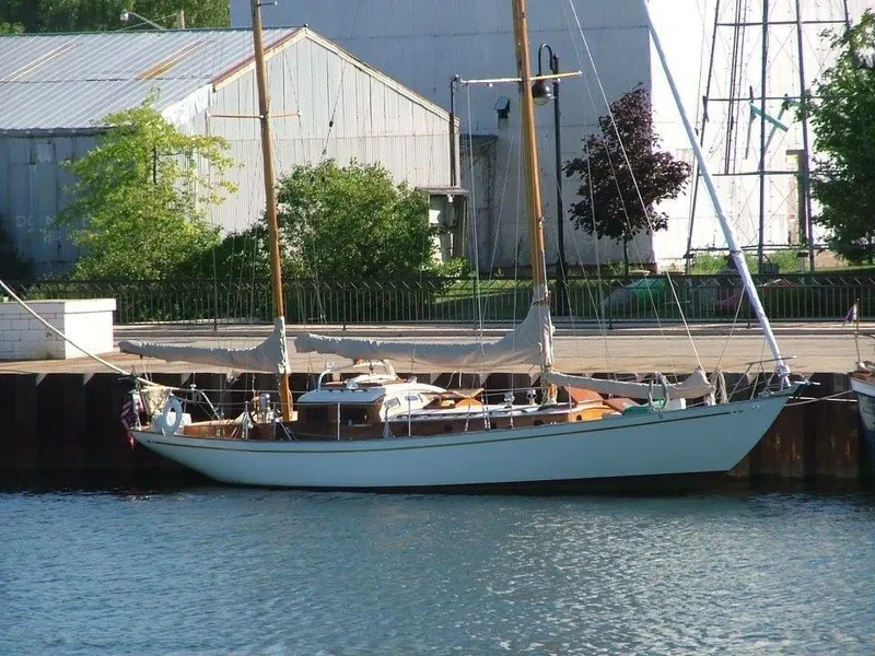 Slide: The Image of 1949 Burger Full Keel Steel Auxiliary Ketch docked by industrial buildings. - 36