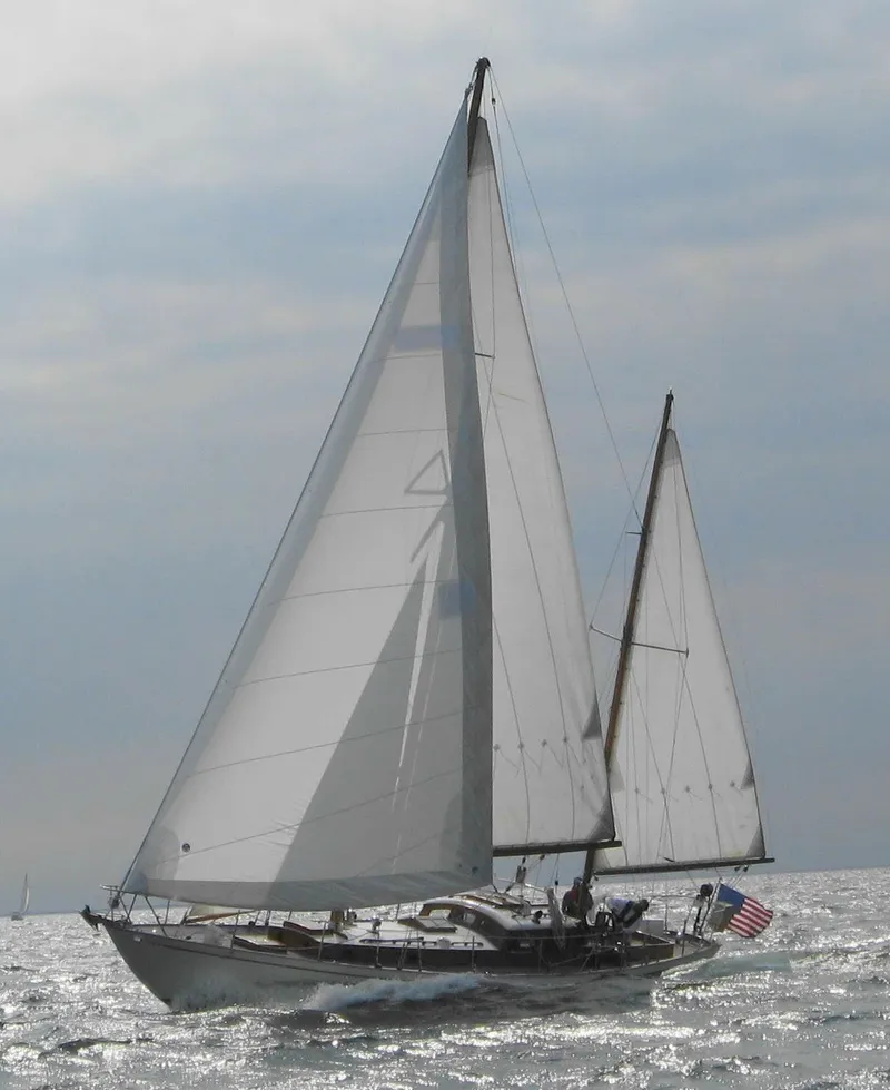 Slide: The Image of 1949 Burger Full Keel Steel Auxiliary Ketch sailing on open water under cloudy skies. - 38