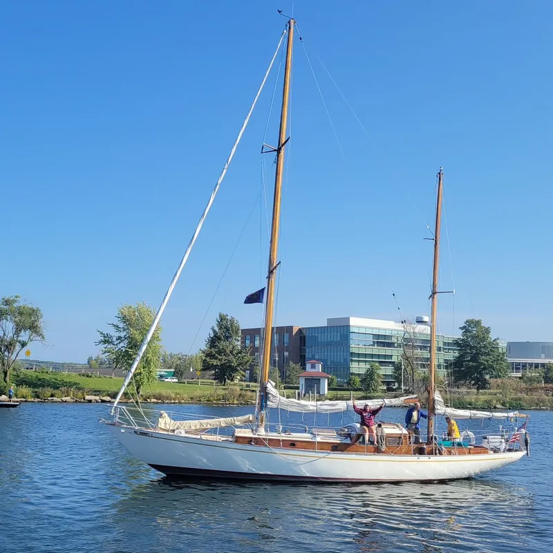 Slide: The Image of 1949 Burger Full Keel Steel Auxiliary Ketch sailing on a sunny day near modern buildings. - 39
