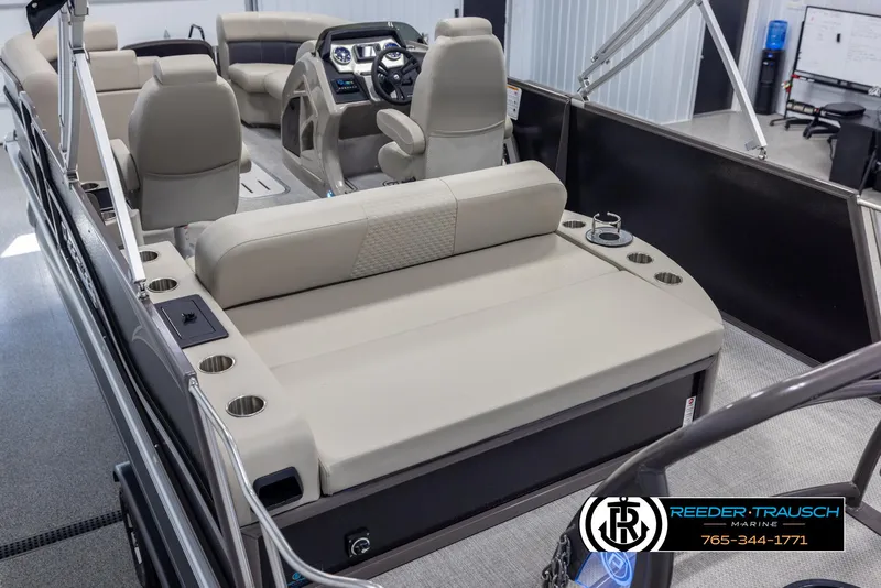Slide: The Image of 2022 Premier 210 Sunsation pontoon boat interior with beige seating and modern dashboard. - 11