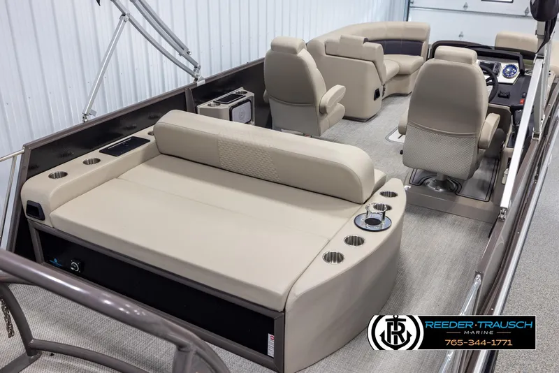 Slide: The Image of Interior of 2022 Premier 210 Sunsation pontoon boat with beige seating and cup holders. - 12
