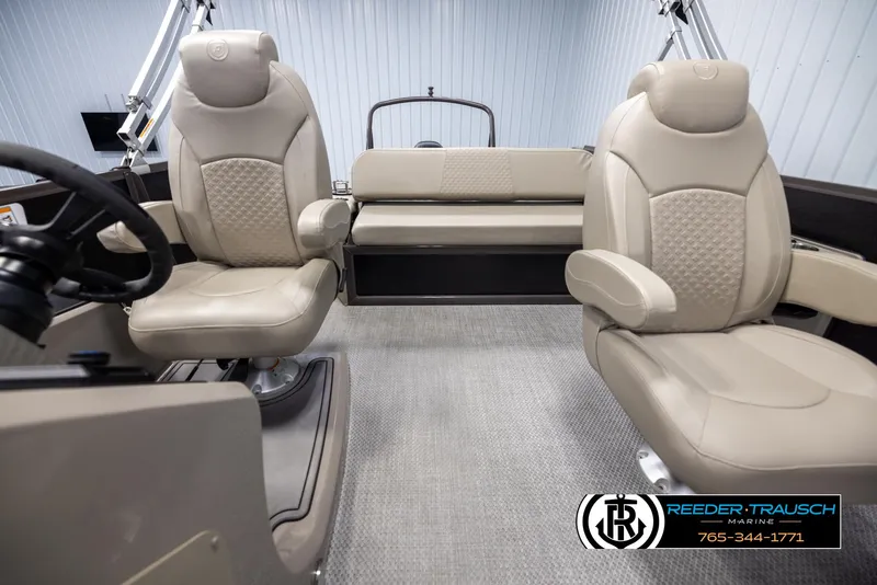 Slide: The Image of 2022 Premier 210 Sunsation boat interior with beige seating and steering wheel. - 14