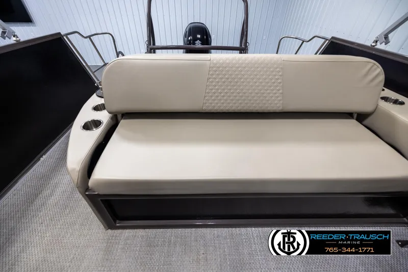 Slide: The Image of 2022 Premier 210 Sunsation boat interior with beige seating and cup holders. - 15