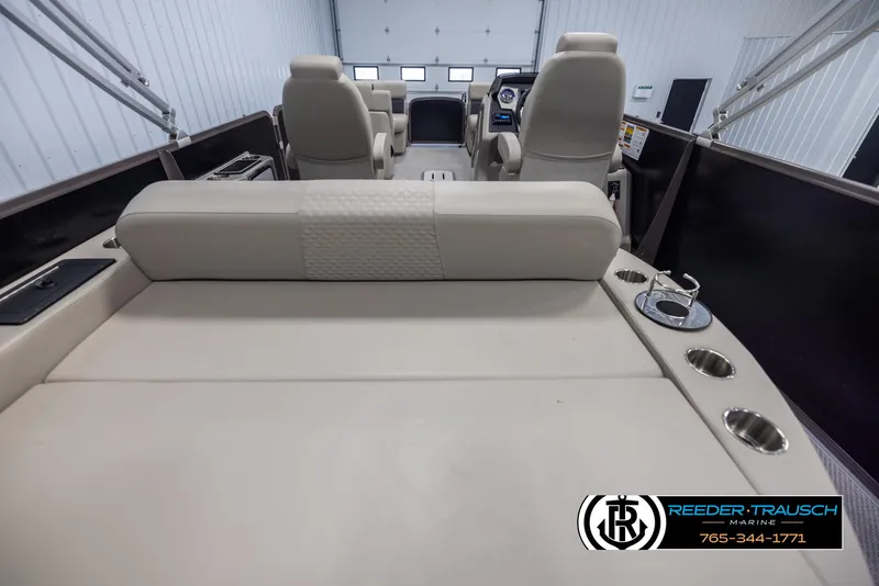 Slide: The Image of 2022 Premier 210 Sunsation boat interior with beige seating and cup holders. - 16