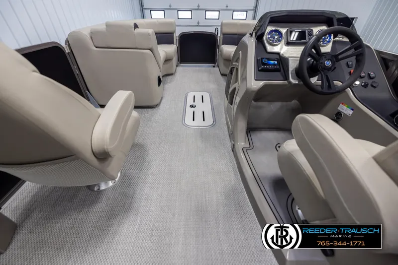 Slide: The Image of 2022 Premier 210 Sunsation boat interior with beige seating and modern dashboard. - 17
