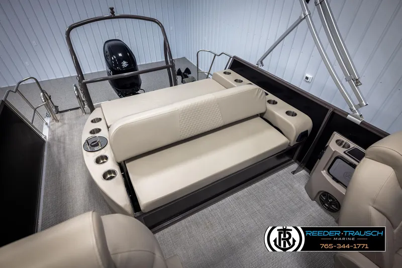 Slide: The Image of 2022 Premier 210 Sunsation boat interior with beige seating and cup holders. - 21