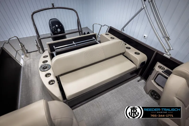 Slide: The Image of 2022 Premier 210 Sunsation boat interior with beige seating and cup holders. - 22