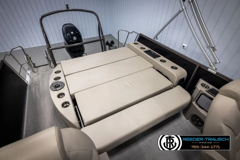 Slide: The Image of 2022 Premier 210 Sunsation boat interior with beige seating and cup holders. - 24