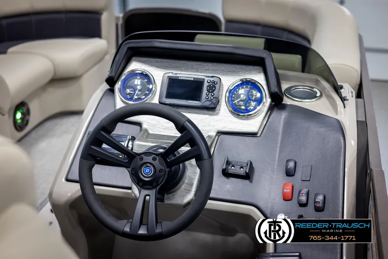 Slide: The Image of 2022 Premier 210 Sunsation boat dashboard with steering wheel and control panel. - 25