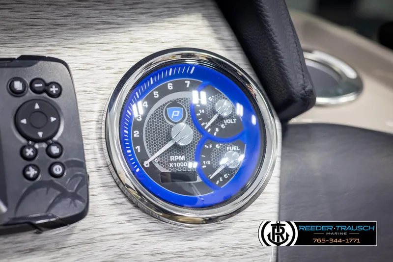 Slide: The Image of Close-up of 2022 Premier 210 Sunsation boat dashboard with RPM and fuel gauges. - 31