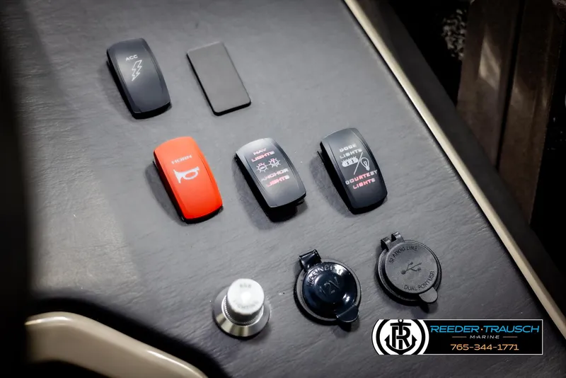 Slide: The Image of Control panel of 2022 Premier 210 Sunsation boat with switches and outlets. - 33