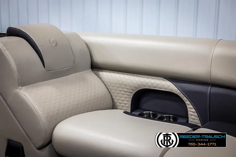 Slide: The Image of 2022 Premier 210 Sunsation boat interior with beige leather seating and cup holders. - 37