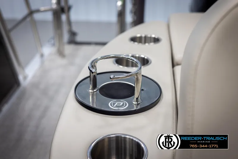 Slide: The Image of 2022 Premier 210 Sunsation boat interior with cup holders and logo detail. - 41