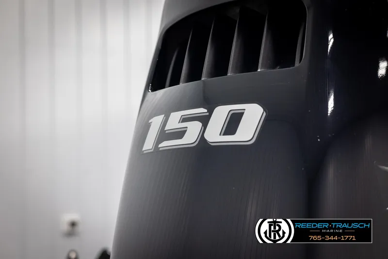 Slide: The Image of Close-up of a 150 HP engine on a 2022 Premier 210 Sunsation boat. - 45