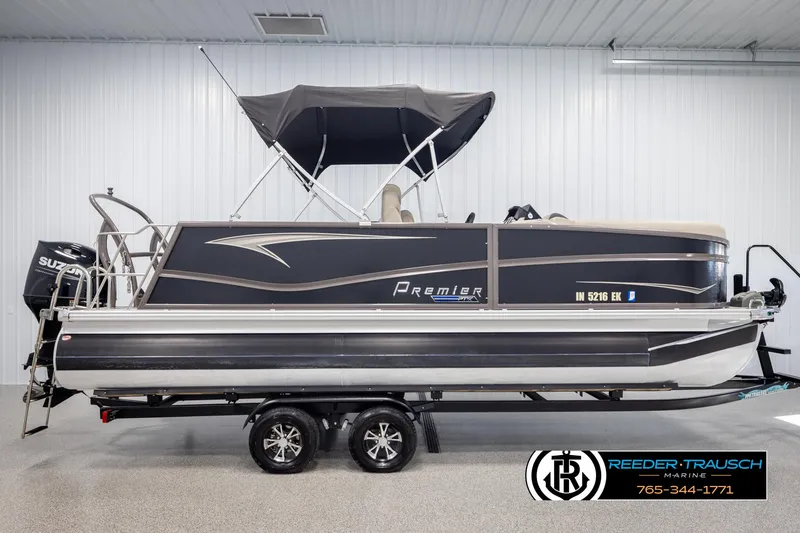 Slide: The Image of 2022 Premier 210 Sunsation pontoon boat with black canopy in showroom. - 5
