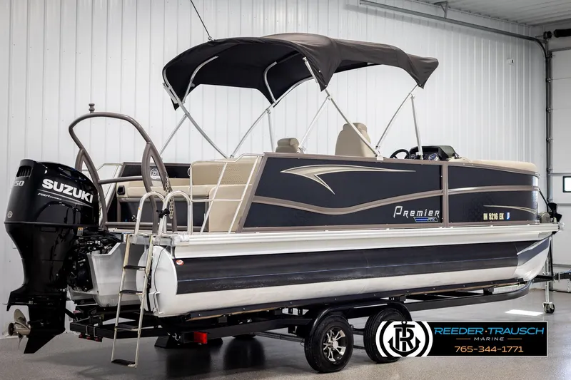 Slide: The Image of 2022 Premier 210 Sunsation pontoon boat with Suzuki outboard motor in showroom. - 6