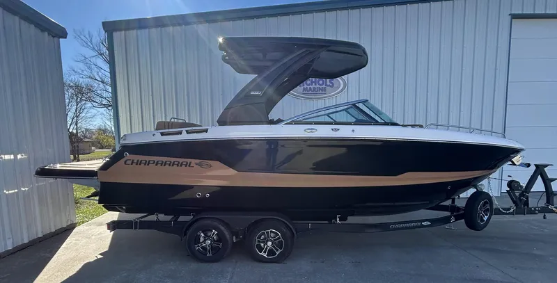 Slide: The Image of 2025 Chaparral 267 SSX boat parked outside a building. - 0
