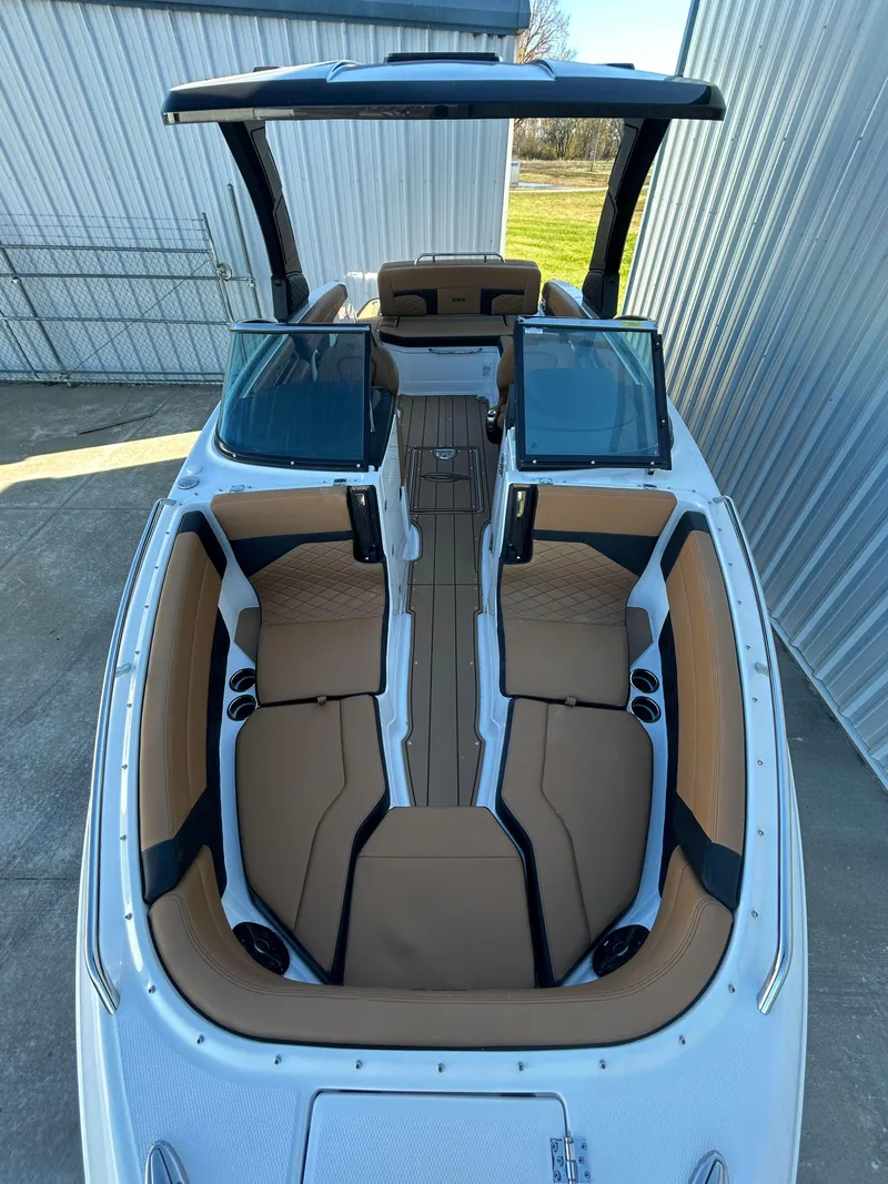 Slide: The Image of 2025 Chaparral 267 SSX boat with spacious seating and sleek design. - 11