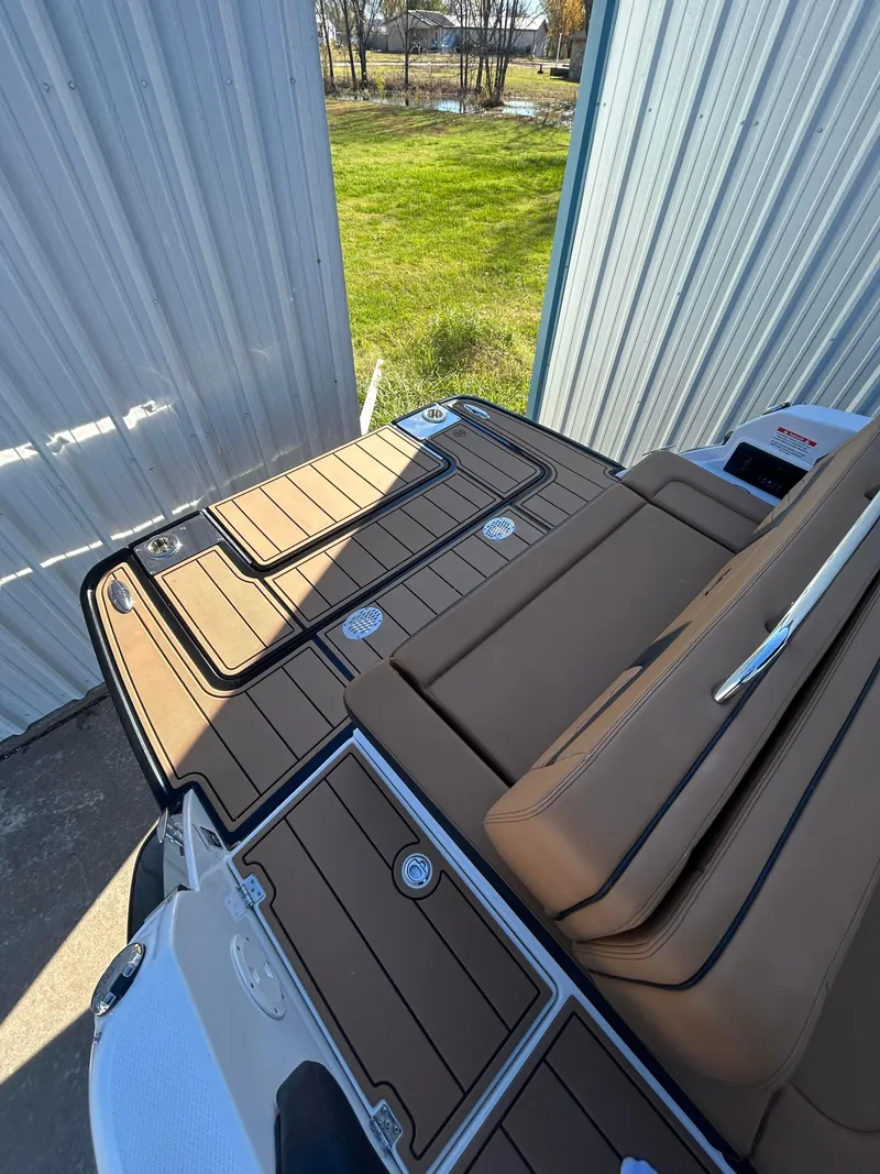 Slide: The Image of 2025 Chaparral 267 SSX boat with tan seating and sleek deck design. - 3
