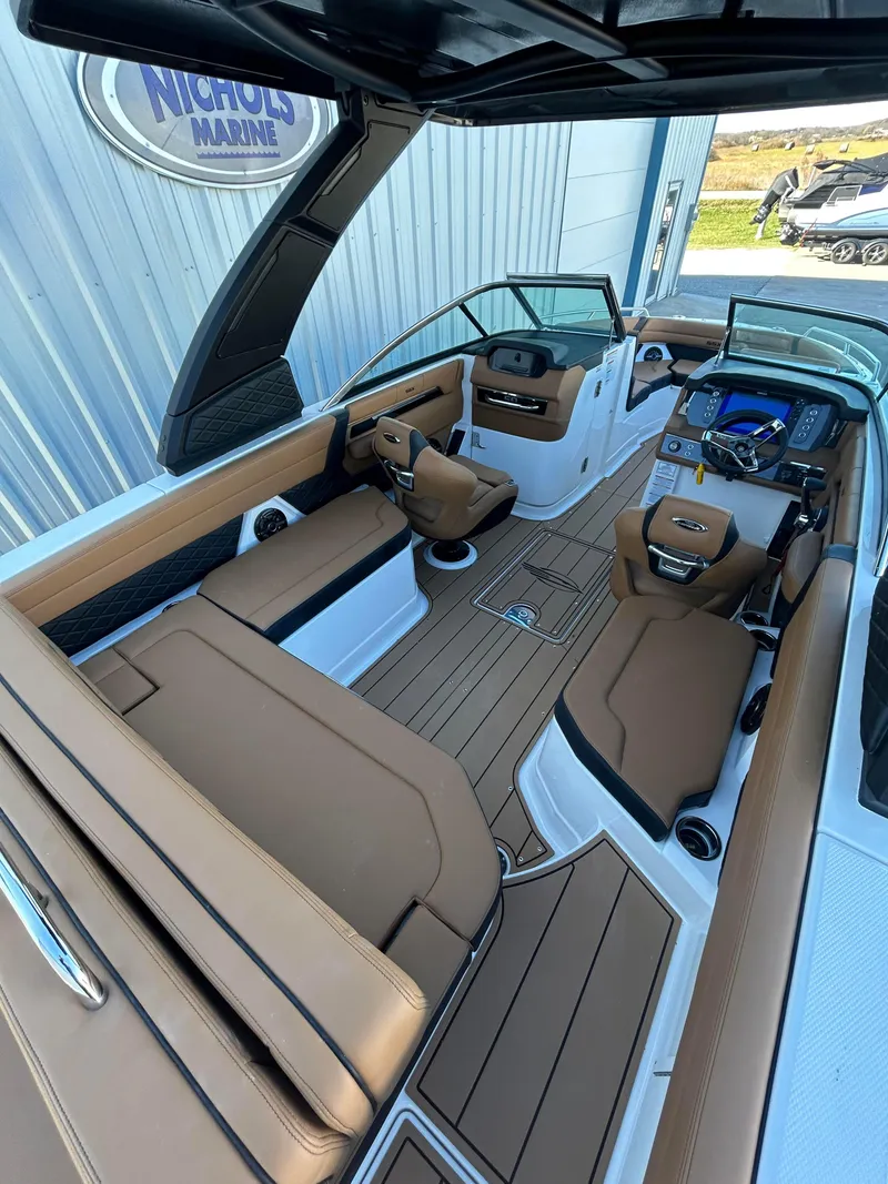 Slide: The Image of 2025 Chaparral 267 SSX boat interior with luxurious seating and modern dashboard. - 5
