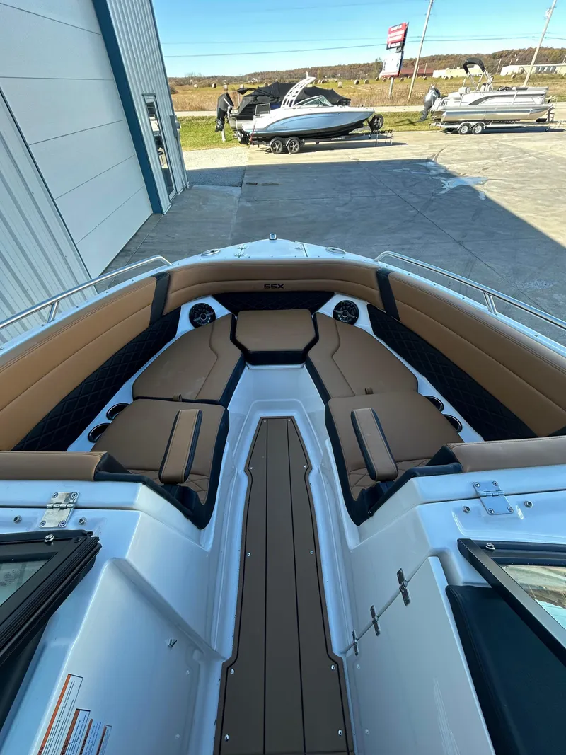 Slide: The Image of 2025 Chaparral 267 SSX boat interior with tan seating and sleek design. - 9
