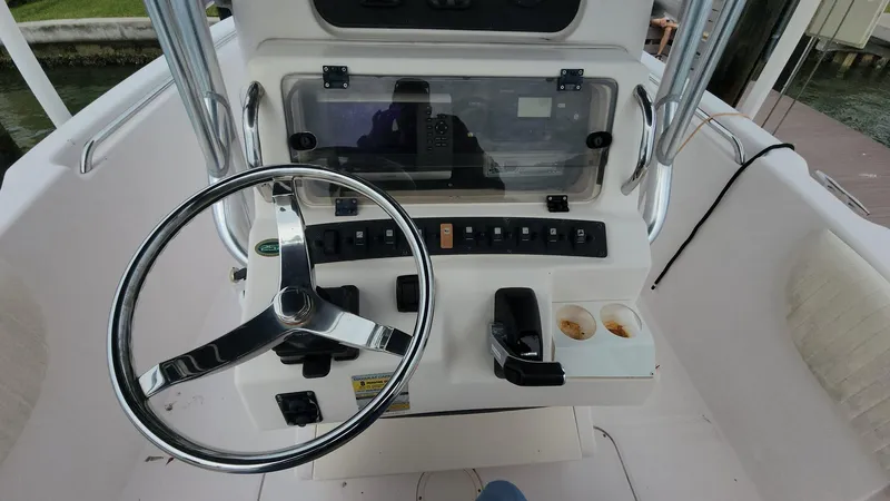 Slide: The Image of 2008 Grady-White Advance 257 boat console with steering wheel and controls. - 1
