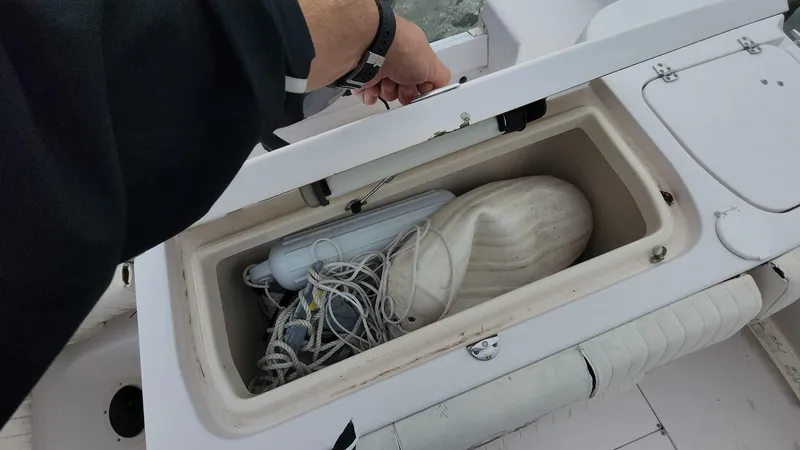 Slide: The Image of Storage compartment on 2008 Grady-White Advance 257 boat with ropes and fender. - 11