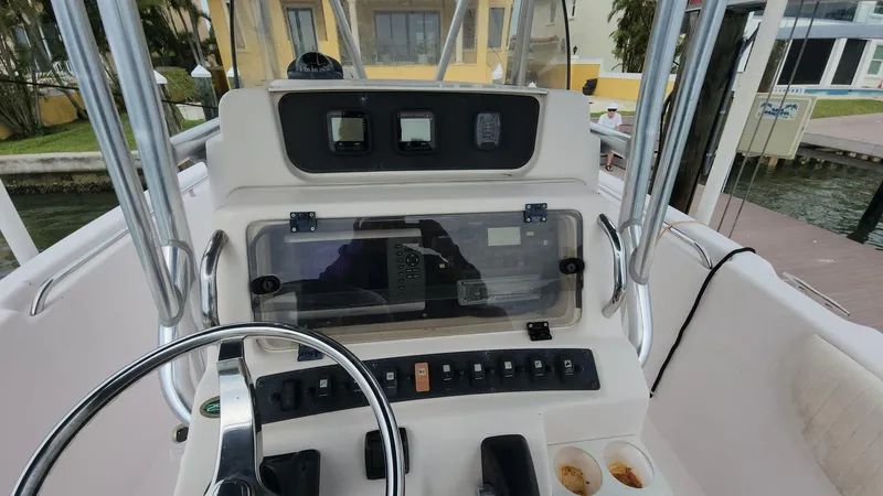 Slide: The Image of 2008 Grady-White Advance 257 boat dashboard with steering wheel and controls. - 12