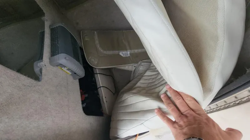 Slide: The Image of Interior of 2008 Grady-White Advance 257 boat with white upholstery and storage compartment. - 17