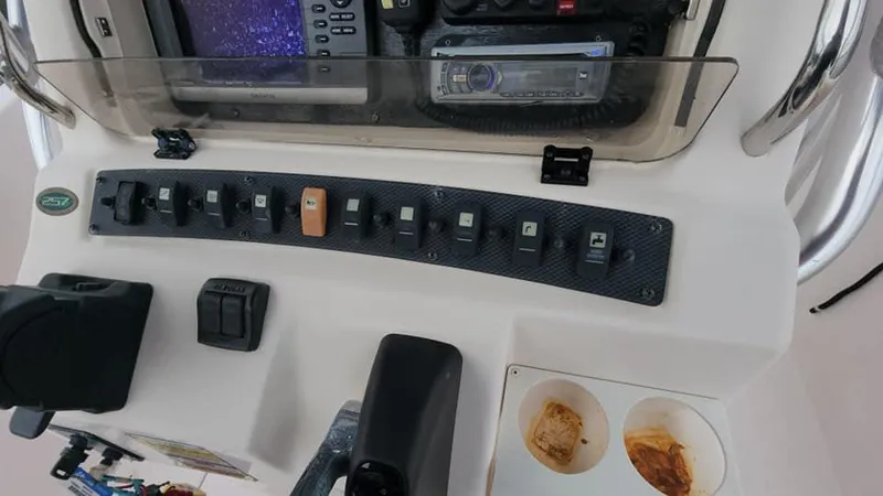 Slide: The Image of Control panel of 2008 Grady-White Advance 257 boat with switches and electronics. - 18