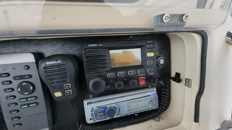 Slide: The Image of 2008 Grady-White Advance 257 boat radio and control panel with Uniden communication system. - 20