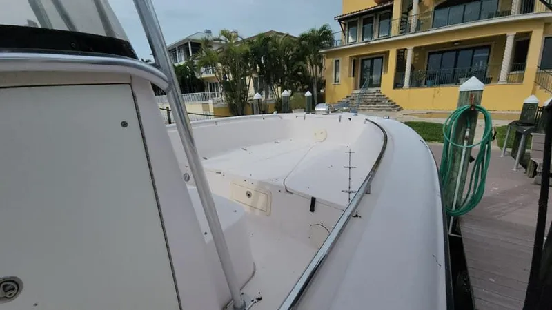 Slide: The Image of 2008 Grady-White Advance 257 boat docked near a yellow house. - 21