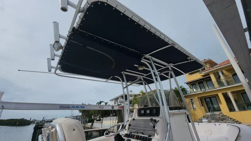 Slide: The Image of 2008 Grady-White Advance 257 boat with T-top, docked near waterfront homes. - 27