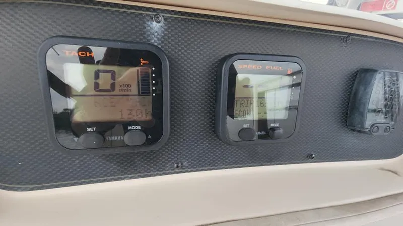 Slide: The Image of Dashboard of 2008 Grady-White Advance 257 boat with tachometer and speed fuel gauges. - 28