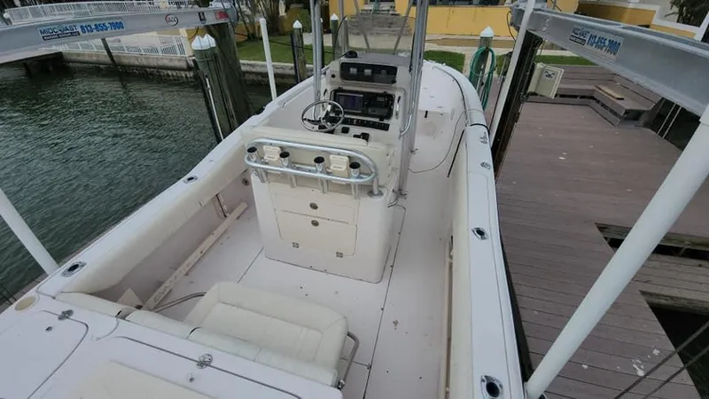 Slide: The Image of 2008 Grady-White Advance 257 boat docked, featuring spacious deck and helm controls. - 4