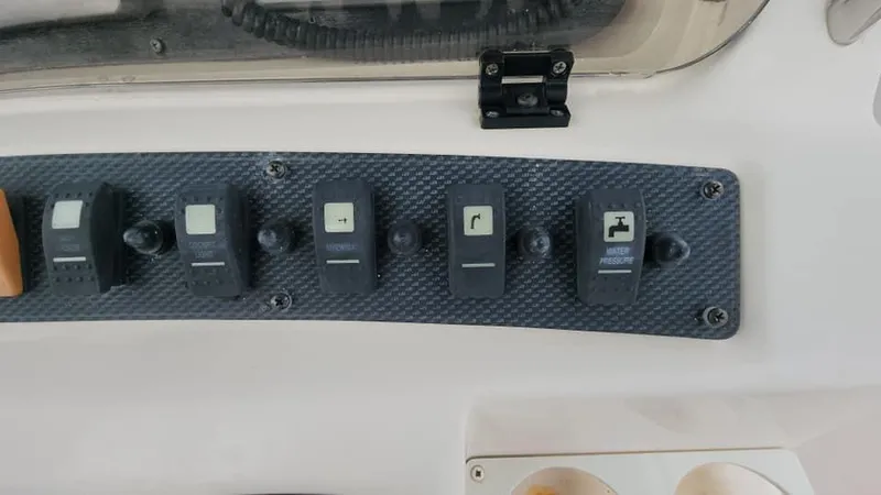 Slide: The Image of Control panel of a 2008 Grady-White Advance 257 boat with multiple switches. - 41