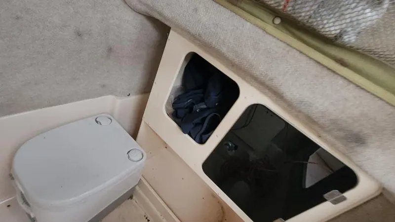 Slide: The Image of 2008 Grady-White Advance 257 boat interior with storage and portable toilet. - 45