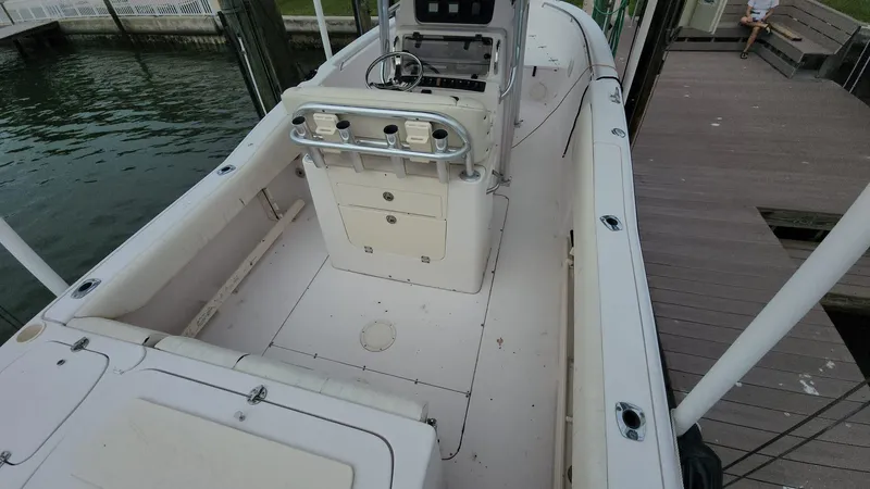 Slide: The Image of 2008 Grady-White Advance 257 boat interior, docked, showcasing spacious deck and console. - 48