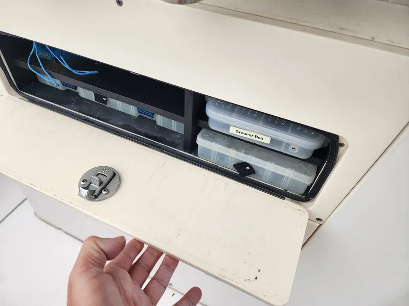 Slide: The Image of Storage compartment on 2008 Grady-White Advance 257 boat with tackle boxes. - 6
