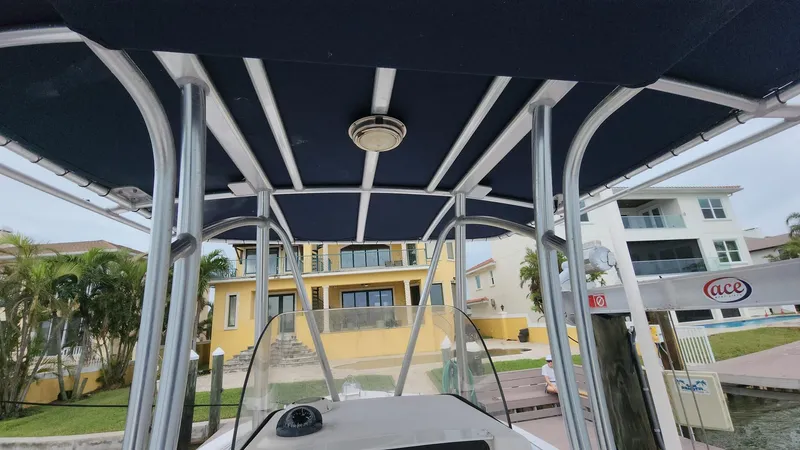 Slide: The Image of 2008 Grady-White Advance 257 boat with canopy, docked near waterfront homes. - 7