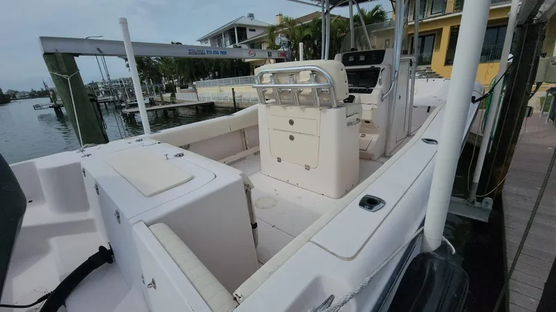 Slide: The Image of 2008 Grady-White Advance 257 boat docked at marina, featuring spacious deck and seating. - 9