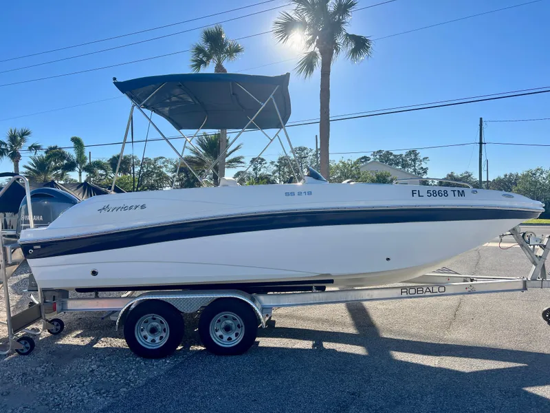 Slide: The Image of 2023 Hurricane 218 SS boat on trailer, sunny day, palm trees in background. - 0