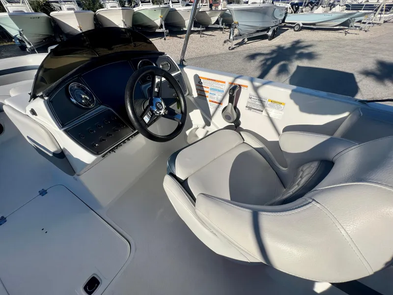 Slide: The Image of 2023 Hurricane 218 SS boat interior with steering wheel and seating. - 10