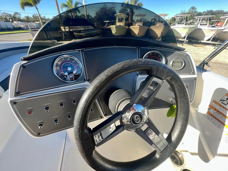 Slide: The Image of 2023 Hurricane 218 SS boat dashboard with steering wheel and gauges. - 11