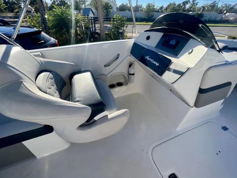 Slide: The Image of 2023 Hurricane 218 SS boat interior with captain's seat and control panel. - 12