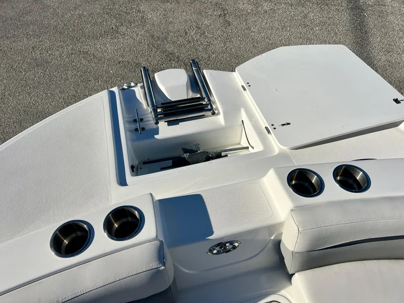 Slide: The Image of 2023 Hurricane 218 SS boat deck with cup holders and storage compartment. - 16
