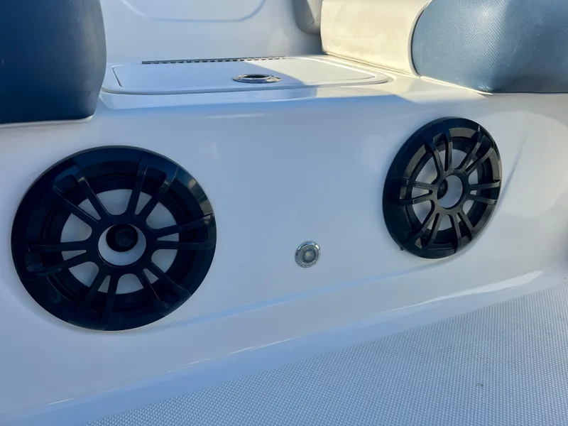 Slide: The Image of 2023 Hurricane 218 SS boat interior with dual speakers and cushioned seating. - 17