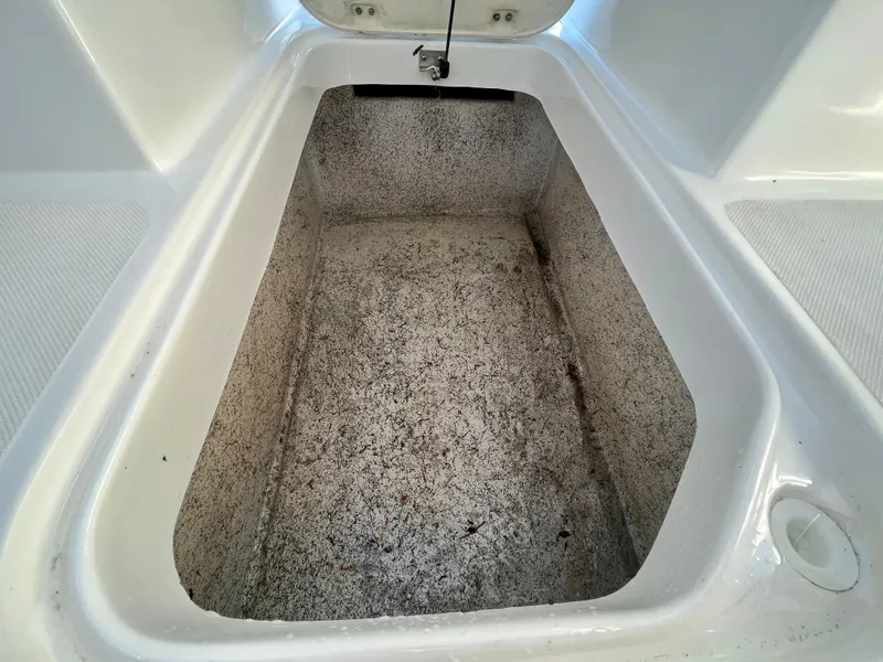 Slide: The Image of 2023 Hurricane 218 SS boat storage compartment, open and empty, with textured interior. - 20