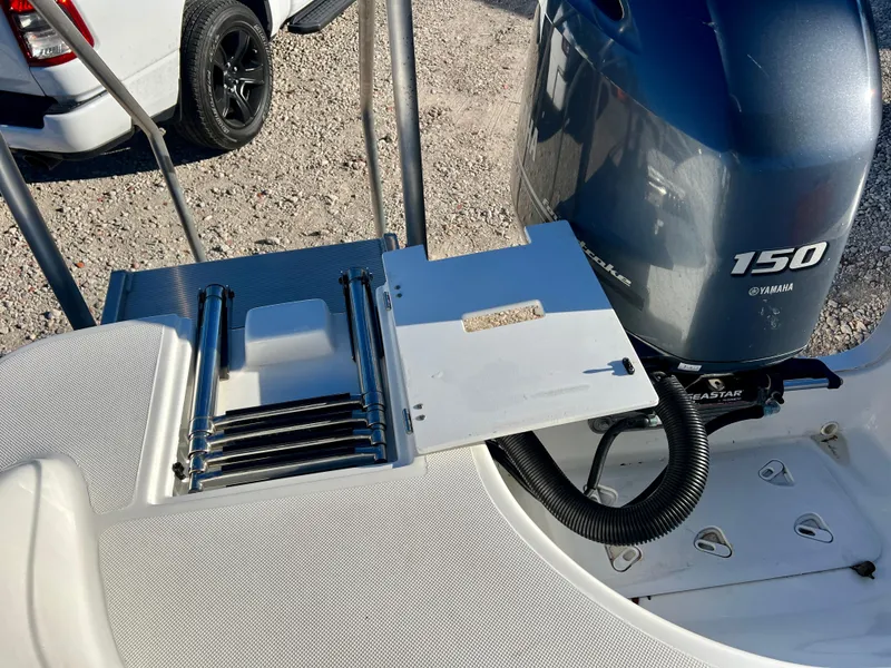 Slide: The Image of 2023 Hurricane 218 SS boat with Yamaha 150 engine and retractable ladder. - 21