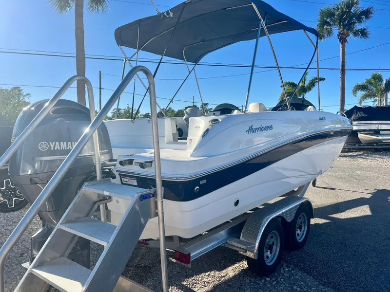 Slide: The Image of 2023 Hurricane 218 SS boat with Yamaha engine on trailer, sunny day. - 7